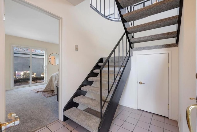 stairway featuring carpet