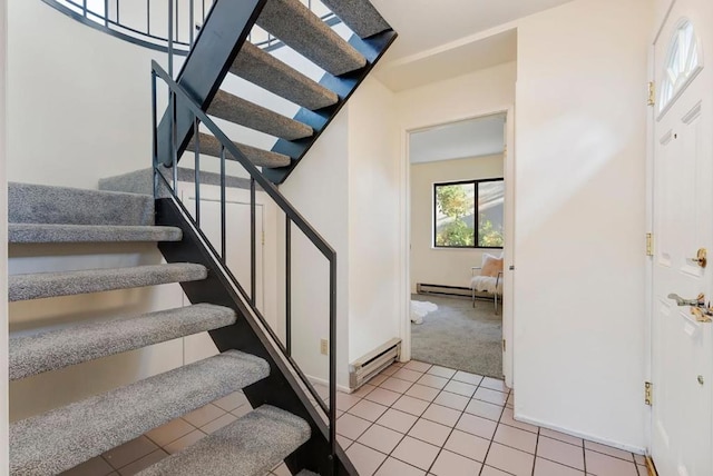 staircase featuring a baseboard radiator and carpet flooring