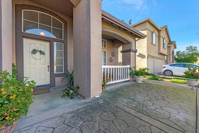 entrance to property with a porch and a garage