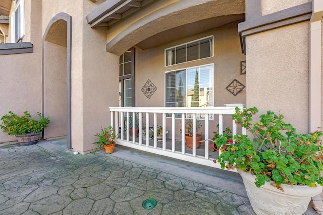 view of exterior entry featuring covered porch