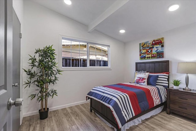 bedroom featuring lofted ceiling with beams and light hardwood / wood-style flooring