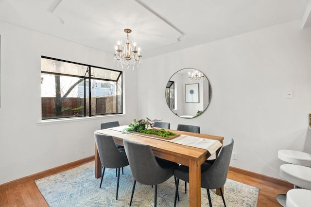 dining room featuring a notable chandelier and light hardwood / wood-style flooring