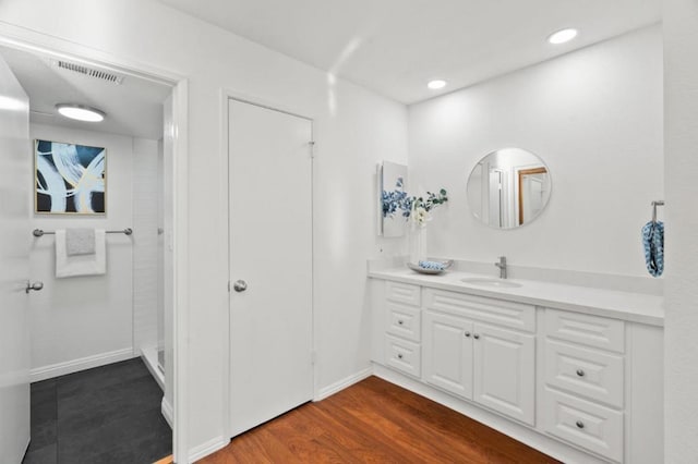 bathroom with vanity, a shower, and hardwood / wood-style floors