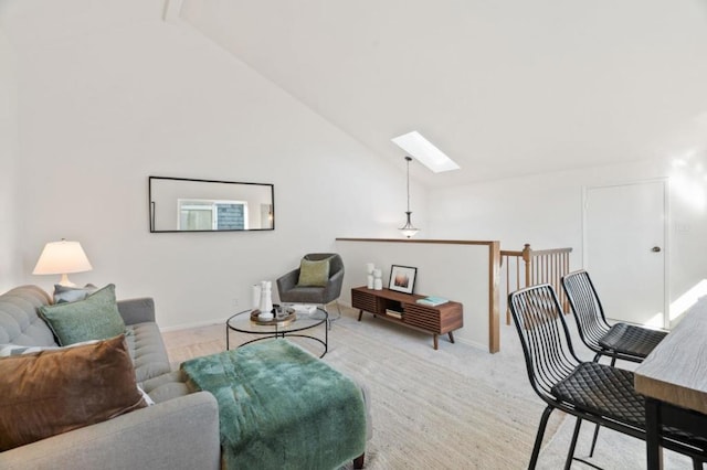 living room featuring light colored carpet, high vaulted ceiling, and a skylight