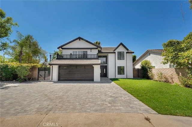 view of front of home with a balcony, a garage, and a front lawn