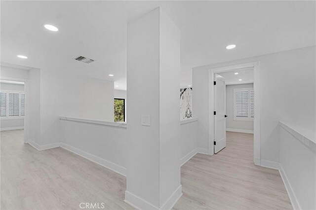 hallway with light hardwood / wood-style flooring