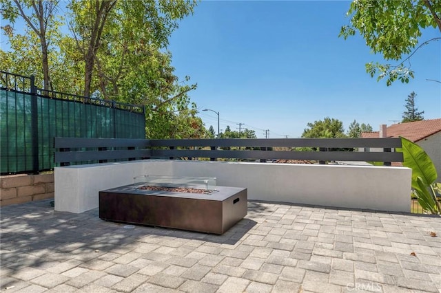 view of patio / terrace featuring an outdoor fire pit