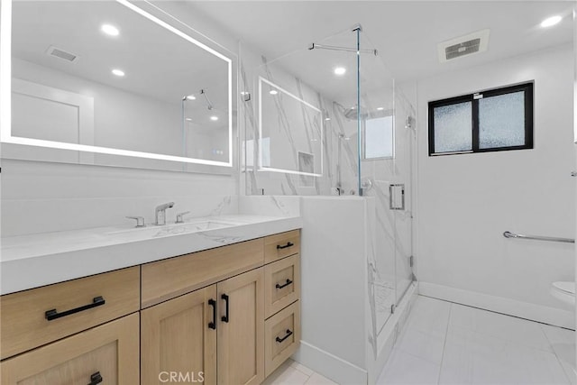 bathroom with vanity, toilet, and an enclosed shower