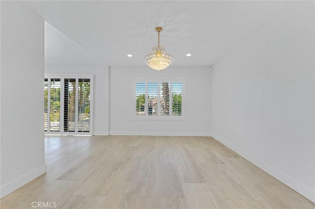 spare room featuring a notable chandelier