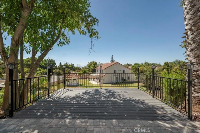 view of gate featuring a wooden deck