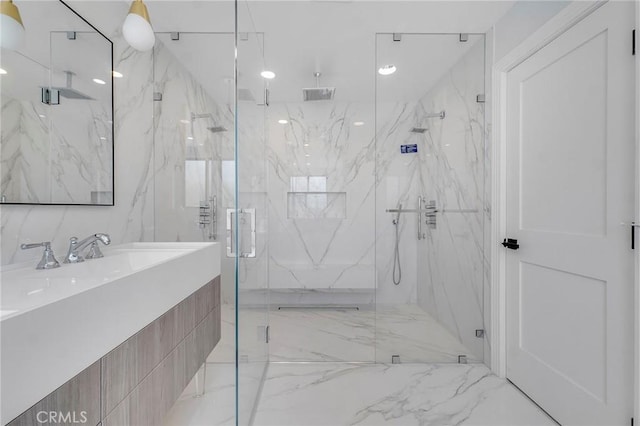 bathroom featuring walk in shower and vanity