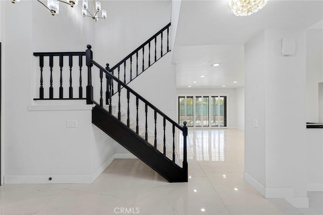 staircase featuring an inviting chandelier