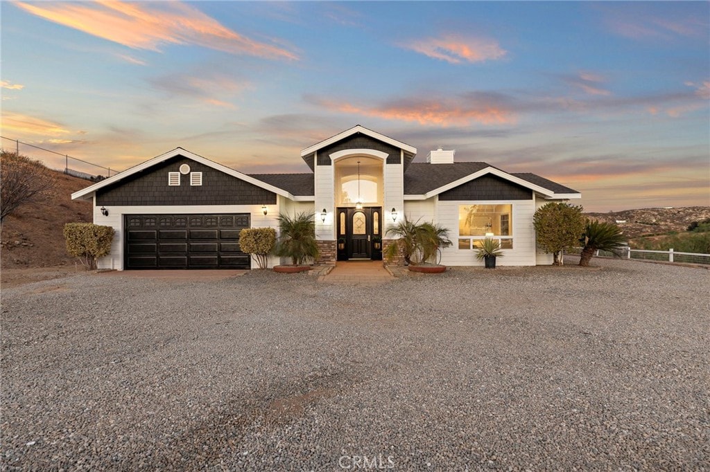 view of front facade with a garage and french doors