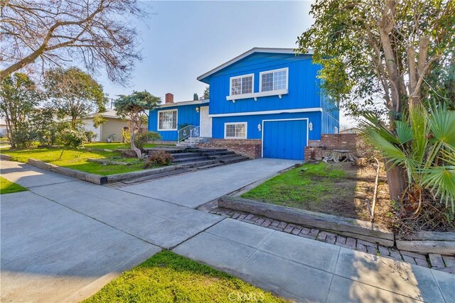 view of front of home with a front yard and a garage