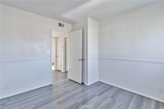 empty room with light hardwood / wood-style floors