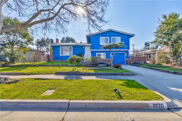 tri-level home with a front lawn and a garage