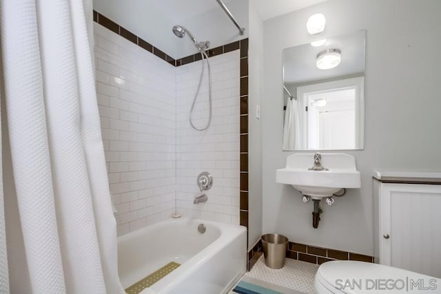 full bathroom featuring toilet, tile patterned flooring, shower / bath combo, and sink