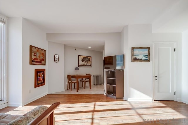 corridor with light hardwood / wood-style floors