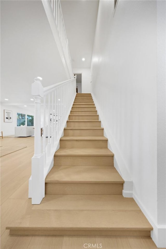 stairway featuring wood-type flooring