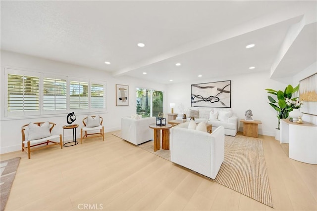 living room with beam ceiling and light hardwood / wood-style floors