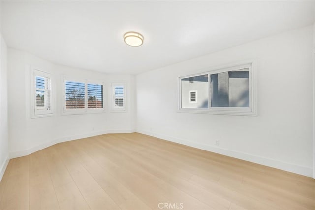 spare room with light wood-type flooring