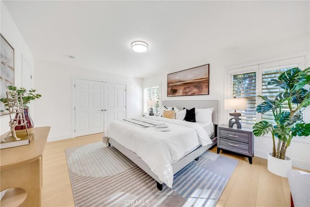 bedroom with a closet and light hardwood / wood-style flooring