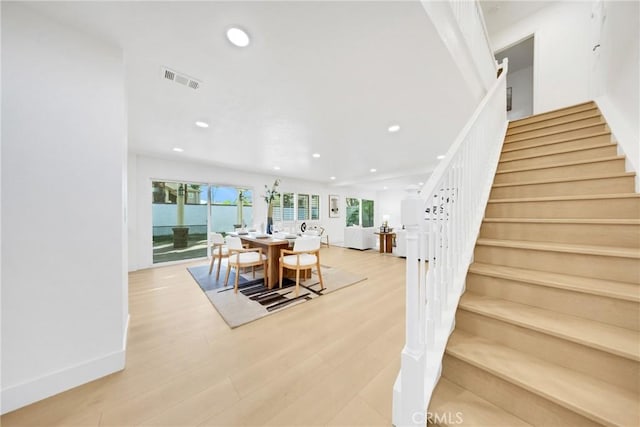 dining space with light hardwood / wood-style floors