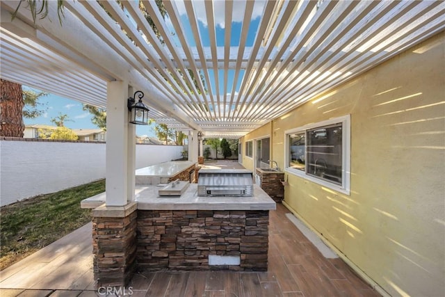 view of patio / terrace featuring area for grilling and a pergola