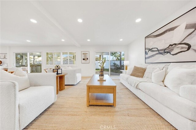 living room with a wealth of natural light and beamed ceiling