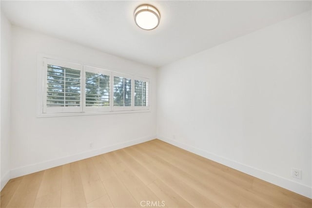 unfurnished room with hardwood / wood-style flooring