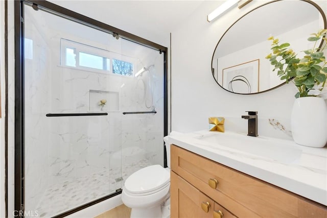 bathroom with vanity, toilet, and walk in shower