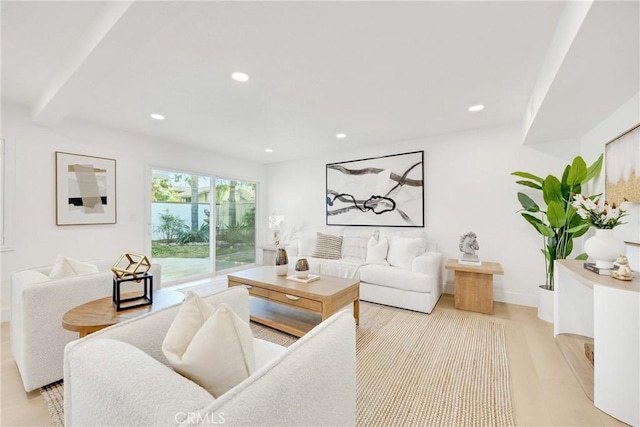 living room with light hardwood / wood-style floors and beamed ceiling