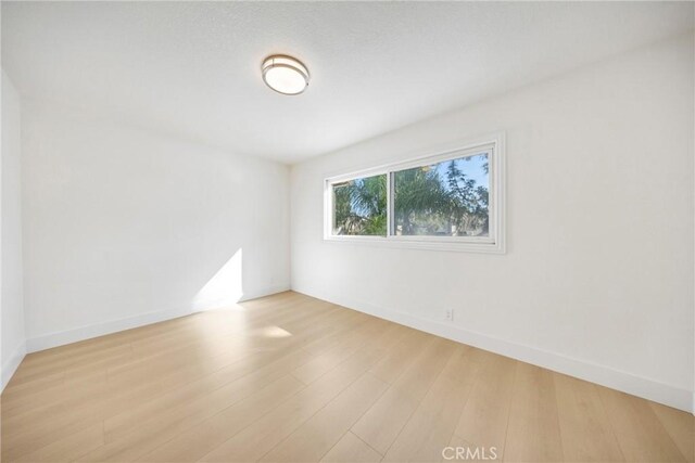 unfurnished room with light wood-type flooring