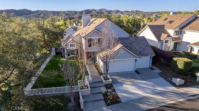 view of front of home with a mountain view and a garage