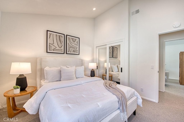 carpeted bedroom featuring high vaulted ceiling and a closet