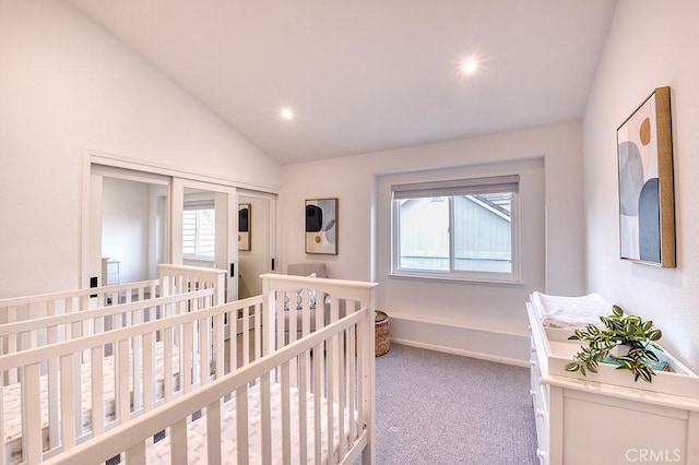 bedroom with lofted ceiling and carpet floors