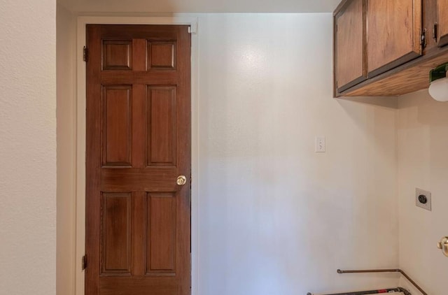 laundry room featuring cabinets and hookup for an electric dryer