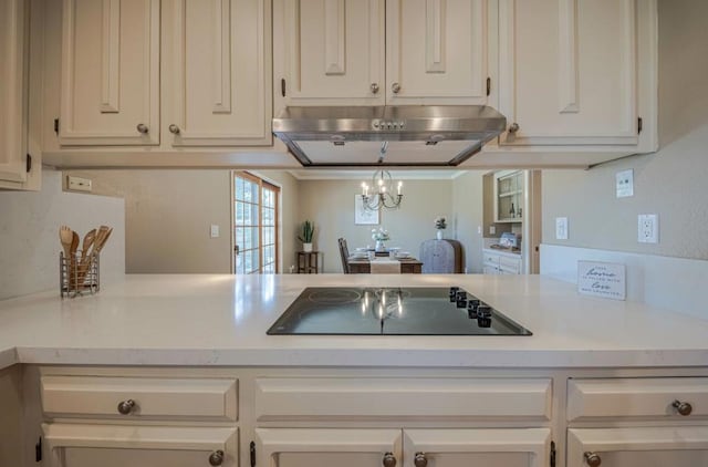 kitchen featuring decorative light fixtures, a notable chandelier, black electric stovetop, white cabinetry, and ventilation hood