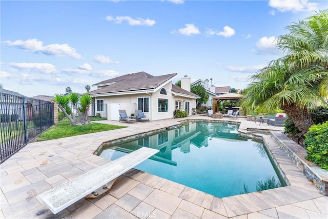 view of swimming pool featuring a gazebo, a diving board, and a patio