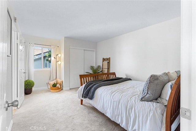 carpeted bedroom featuring a closet