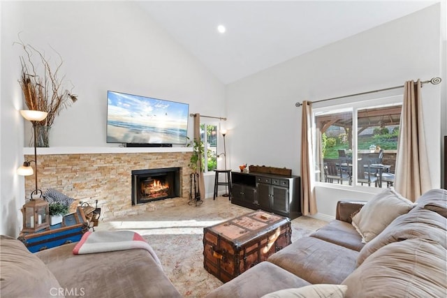 living room with a fireplace and high vaulted ceiling