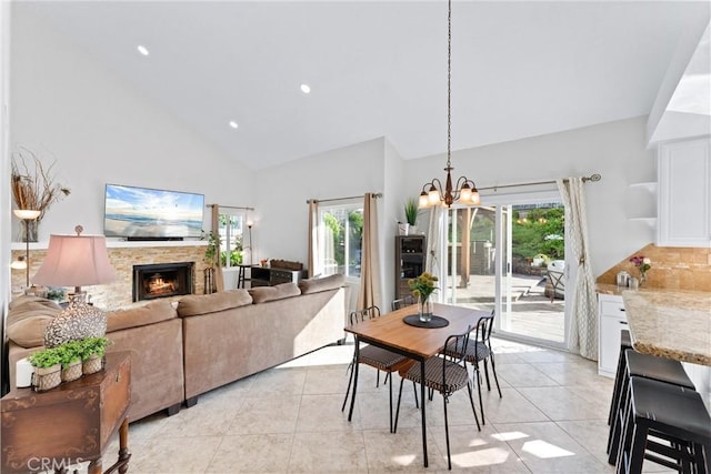 dining area featuring light tile patterned flooring, a healthy amount of sunlight, and a chandelier