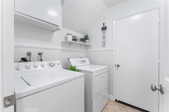 washroom with light tile patterned flooring and washing machine and clothes dryer