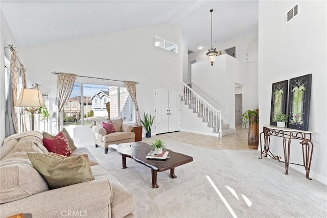 carpeted living room with lofted ceiling with beams