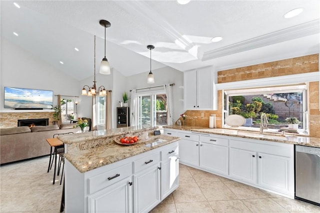 kitchen featuring a kitchen island, decorative light fixtures, white cabinetry, dishwasher, and sink