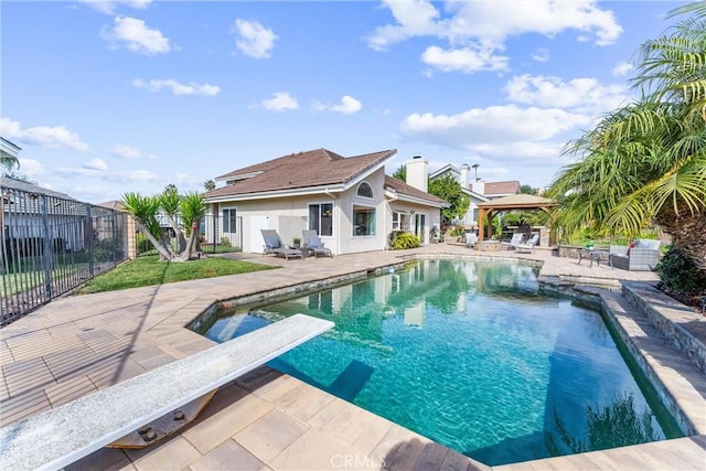 view of pool with a gazebo, a diving board, and a patio area