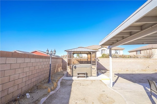 view of patio / terrace with a gazebo and a hot tub