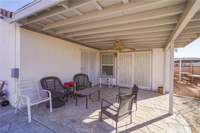 view of patio featuring ceiling fan