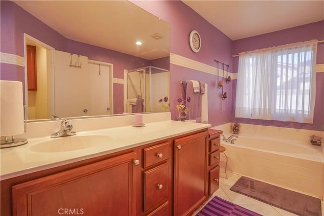 bathroom with vanity, tile patterned floors, and shower with separate bathtub