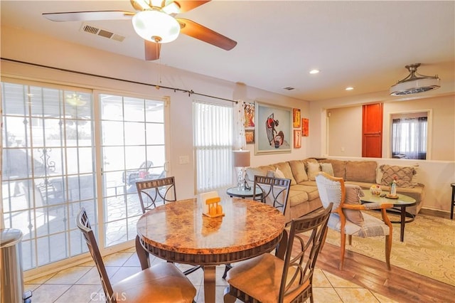 dining space with a wealth of natural light, light tile patterned floors, and ceiling fan